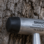 Close-up of a sounding mallet used to check for internal decay in an oak tree.