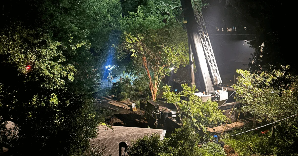 Emergency tree removal team in Milton, FL using crane-assisted equipment to clear storm-damaged oak