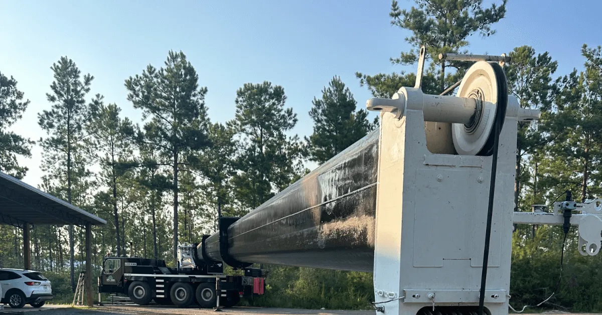 Certified arborist performing crane-assisted tree removal in Brent, FL yard
